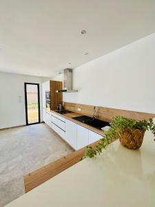 a kitchen with a sink and a counter top at Villa du grangeon in Rosières