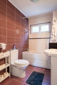 a bathroom with a toilet and a tub and a sink at Apartment Wish - two bedrooms with 2 AC renewed in Pag +17 photos