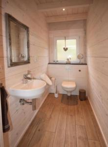 a bathroom with a sink and a toilet at Blockhaus Edelweiss in Rieden +61 photos