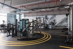 a gym with cardio equipment and a mural at Frank Porter - Studio One in Dubai