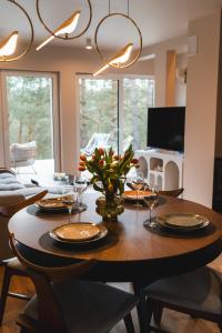 a dining room table with wine glasses and flowers on it at Leśny Duet in Huta Podgórna +24 photos