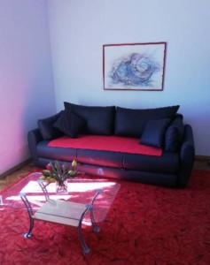 a living room with a couch and a table at Apartment Red Coral in Dubrovnik