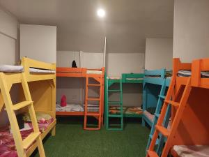 a room with several bunk beds in it at Sun Valley Hostel in El Nido