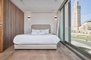 a bedroom with a large bed and a large window at Sea View & Hassan 2 Mosque By TheCasaEdition (B18) in Casablanca