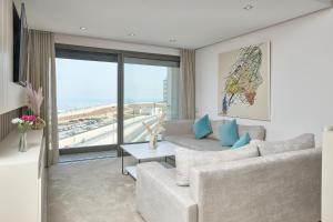 a living room with a couch and a large window at Sea View & Hassan 2 Mosque By TheCasaEdition (B18) in Casablanca