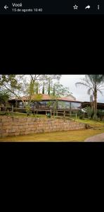 a picture of a train passing by a stone wall at Pousada Rural em Braganca Paulista in Bragança Paulista