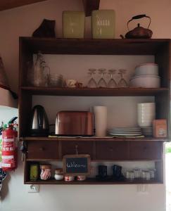 un estante con platos y platos. en 10 da Muralha, en Estremoz