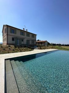 a house with a swimming pool in front of a house at Podere Mantignano 2 in Faenza