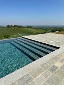 a swimming pool with a view of the water at Podere Mantignano 2 in Faenza