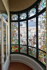 a large stained glass window in a room at Hotel Castel Jeanson in Ay