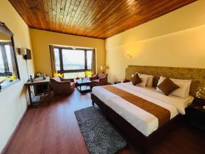 a bedroom with a large bed and a living room at Sandhu Farm in Anjuna