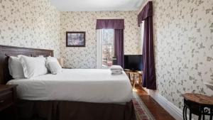 a bedroom with a large bed and a window at Governor's Mansion beautiful 3bd with pool table in Leadville +23 photos