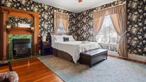 a bedroom with a bed and a fireplace at Governor's Mansion beautiful 3bd with pool table in Leadville