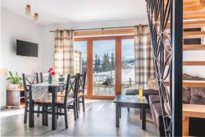 a dining room and living room with a table and chairs at Anielska Osada in Groń