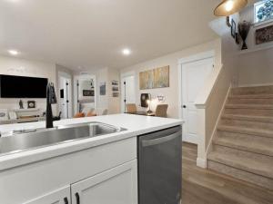 a kitchen with a sink and a living room at Leadville's Copper Top Getaway in Leadville