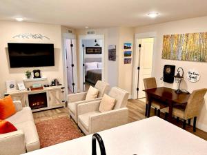 a living room with a couch and chairs and a television at Leadville's Copper Top Getaway in Leadville