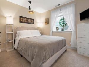 a bedroom with a bed and a dresser and a window at Leadville's Copper Top Getaway in Leadville
