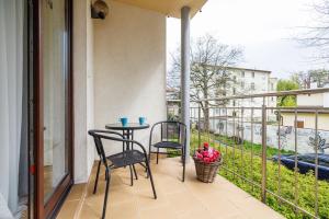 a balcony with two chairs and a table on it at Lapwing Apartments - Comfort in Sopot