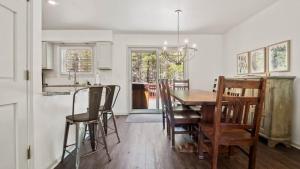 a kitchen and dining room with a wooden table and chairs at Mountain Home with Amazing Views and Hot Tub in Leadville