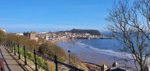 a view of a beach with a town in the background at Stones Throw in Scarborough