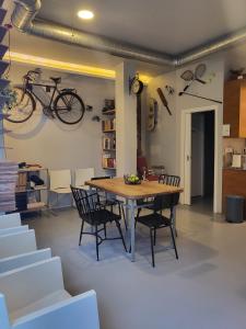 a dining room with a table and a bike on the wall at Acolá Sport Hostel in Pontevedra