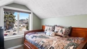 a bedroom with a bed and a large window at Mom's House - 1 block from downtown & Hot Tub in Leadville