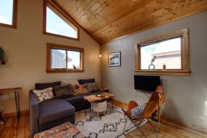 a living room with a couch and a table at Little Lodge Leadville: charming 2bd in Leadville