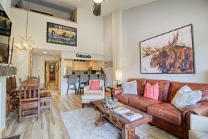 a living room with a couch and a table at Unit 520 - 3br condo with balcony views in Avon
