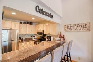 a kitchen with a counter top and a refrigerator at Unit 520 - 3br condo with balcony views in Avon