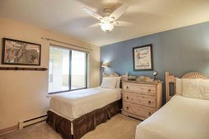 a bedroom with two beds and a ceiling fan at Unit 520 - 3br condo with balcony views in Avon