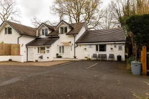 a white house with a driveway in front of it at Roger Ground Guest House - with Onsite Car Parking in Windermere