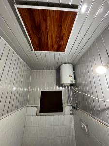 een badkamer met een televisie aan de muur en een plafond bij Dream Land Hotel in Jammu
