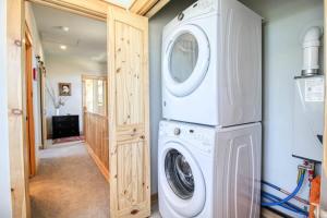 a laundry room with a washer and dryer at Modern 3bd cabin in Edgewater in Granby +42 photos