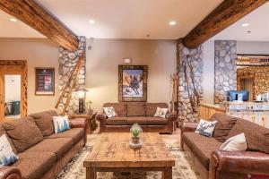 a living room with two couches and a table at NEW Listing Perfect Location 414 with Heated Pool and Hot Tub in Crested Butte