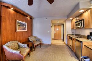 a kitchen with two chairs and a counter in a room at NEW Listing Perfect Location 414 with Heated Pool and Hot Tub in Crested Butte