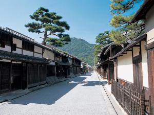 an empty street in an asian town with buildings at 近江八幡ステーションホテル in Omihachiman