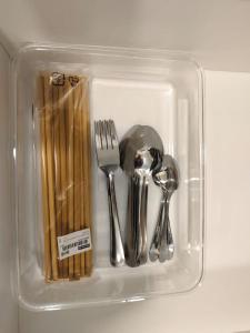 a plastic container filled with utensils and chopsticks at MUJI Cosy Level 25th Room Amber Residence @ Quayside Mall Rimbayu Near to Masha Oasis Tenby KLIA Kota Kemuning in Teluk Panglima Garang
