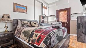a bedroom with a bed with a blanket on it at Papa's Place - blocks from downtown in Leadville
