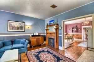 a living room with a blue couch and a fireplace at The Victorian Aspen Grove- 2bd w Sauna & Gym in Leadville