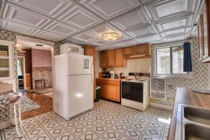 a kitchen with a white refrigerator in a room at The Victorian Aspen Grove- 2bd w Sauna & Gym in Leadville