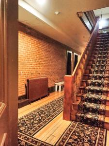 an empty room with stairs and a brick wall at Papa's Place - blocks from downtown in Leadville +11 photos