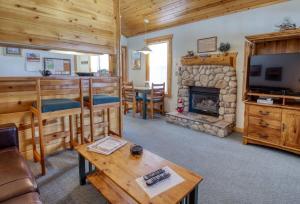 a living room with a television and a fireplace at Lackawanna 1A in Leadville
