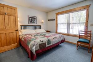 a bedroom with a bed and a window and a chair at Lackawanna 1A in Leadville