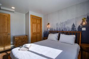 a bedroom with a large bed with a wooden headboard at The Hilltop Haven 2bd Suite and Pet Friendly in Leadville