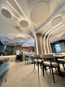 a restaurant with chairs and tables and a bar at lyf Schönbrunn Vienna in Vienna