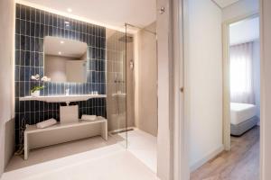 a bathroom with a sink and a mirror at Aqualuz Lagos by The Editory in Lagos