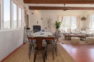 a living room with a wooden table and chairs at Renovated Lodge - Room 1 with pool access in Joshua Tree