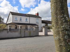 a white house on the side of a street at Pendle View Apartments in Blackburn