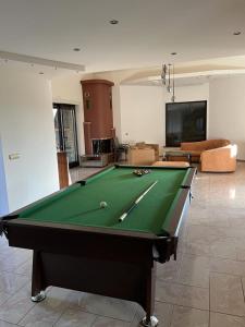 a living room with a pool table in a room at Willa w Piszu in Pisz