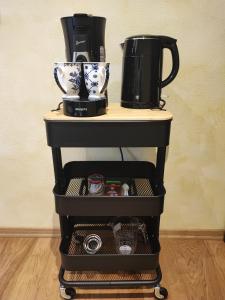 a coffee cart with a coffee maker on top of it at PARK VILLA zentral am Mittelrhein Zimmer&Apartments Self check in Aparthotel in Boppard
